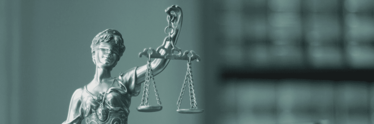 A legal statue of a blindfolded woman holding a scale.