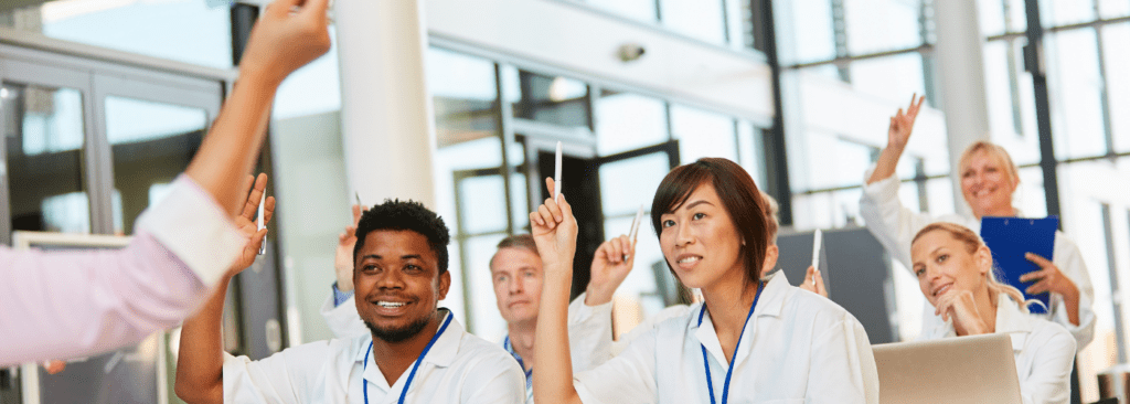 Diversity group of people raising their hands.