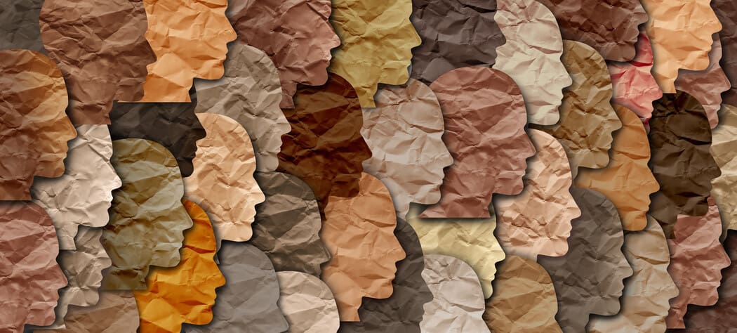 The image displays a collage of human profile silhouettes, all facing to the right, layered over each other. Each silhouette has a crumpled paper texture and is rendered in various shades of brown, beige, tan, and ochre, representing a range of skin tones.