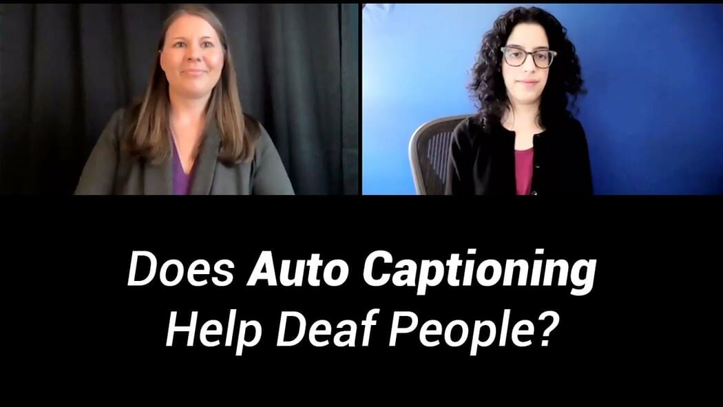 The image is a split-screen video call display showing two women. The woman on the left has long brown hair, wearing a dark blazer over a purple top, and is seated in front of a black curtain. The woman on the right has curly dark hair, wearing glasses, a black cardigan, and a pink top, seated against a vivid blue background. Below the video call image is a black bar with large, white text asking a question, "Does auto-captioning help deaf people?"